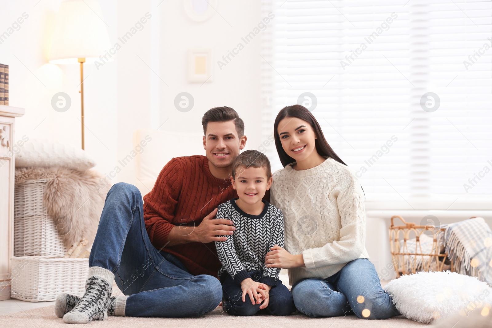 Photo of Happy family with little son spending time together at home. Winter vacation