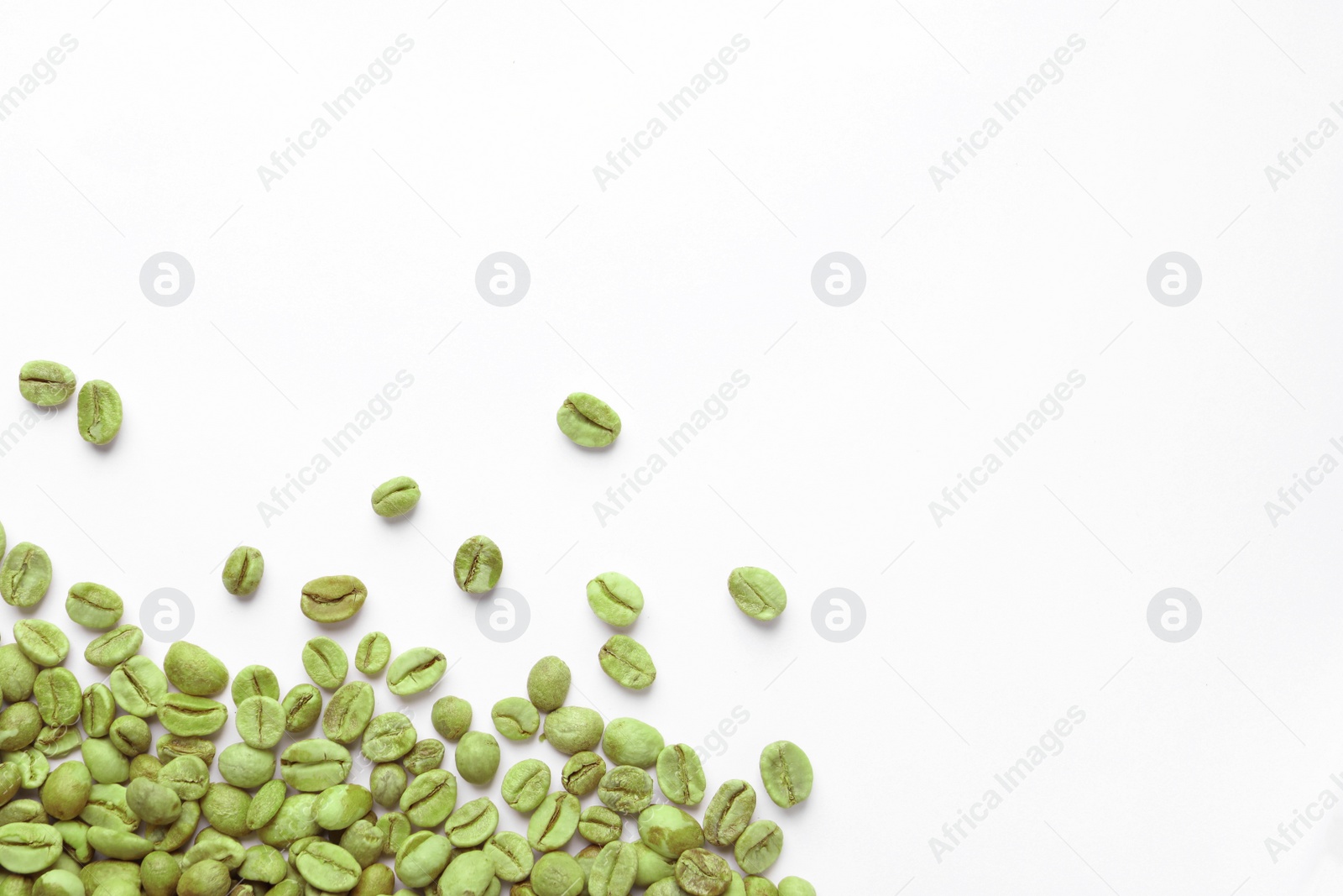 Photo of Many green coffee beans on white background, top view