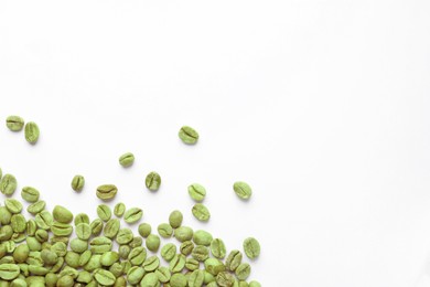 Many green coffee beans on white background, top view