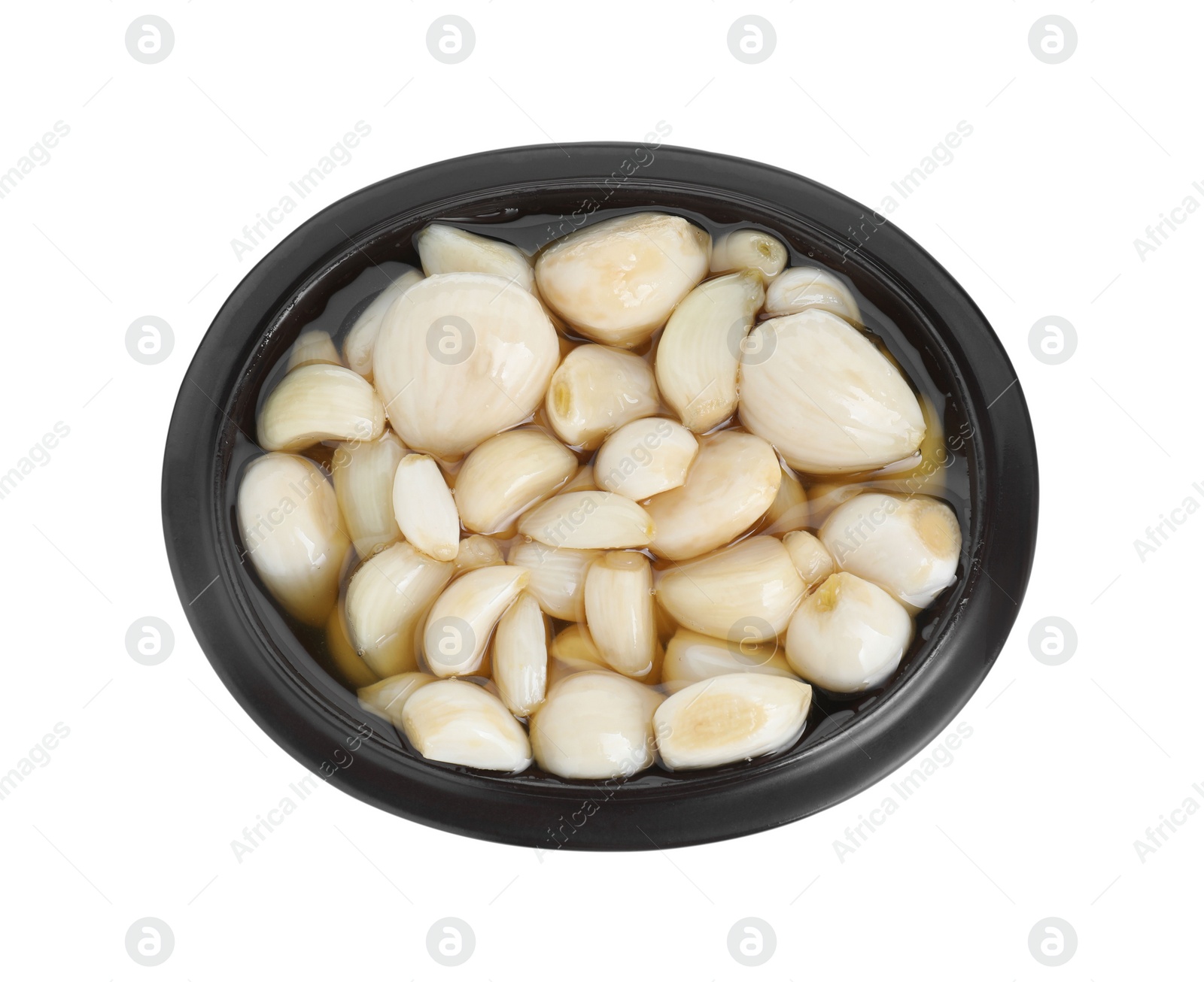 Photo of Peeled garlic cloves with honey in bowl isolated on white, top view