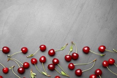 Photo of Delicious cherries on grey background, flat lay