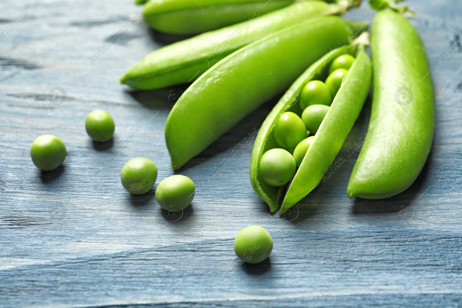 Photo of Fresh green peas on wooden background, closeup