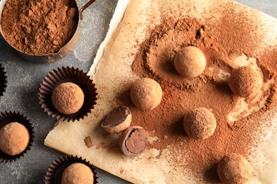 Flat lay composition with chocolate truffles on grey background