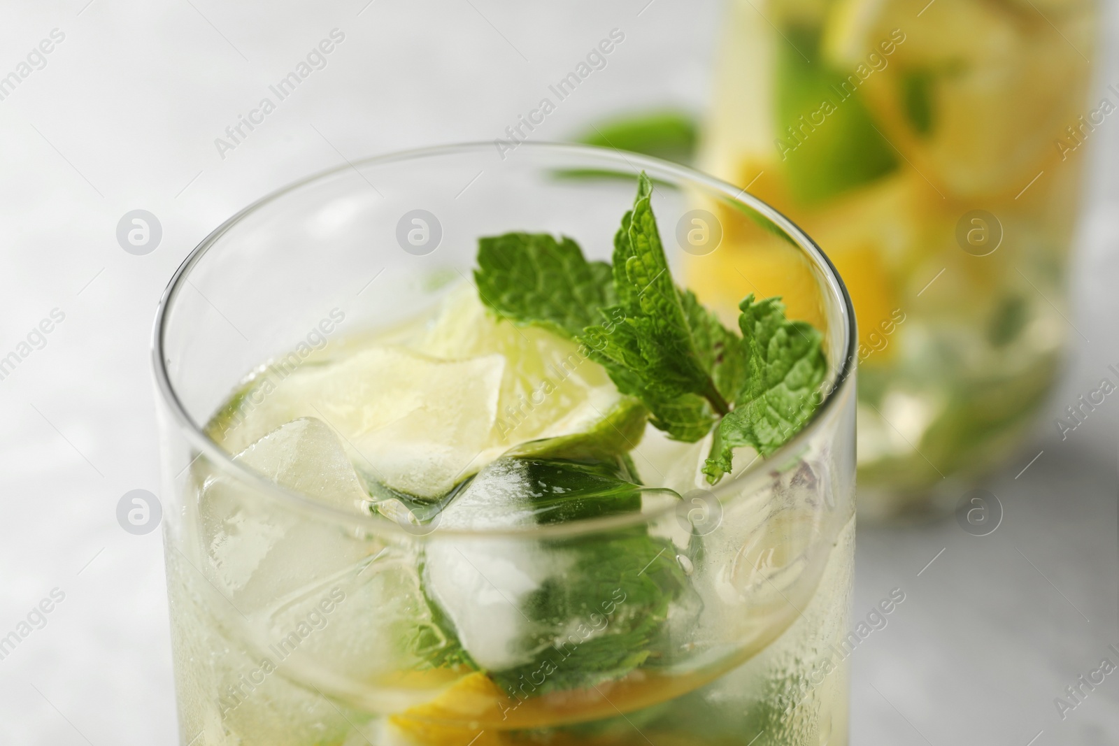 Photo of Glass of refreshing lemonade with mint on table, closeup. Summer drink