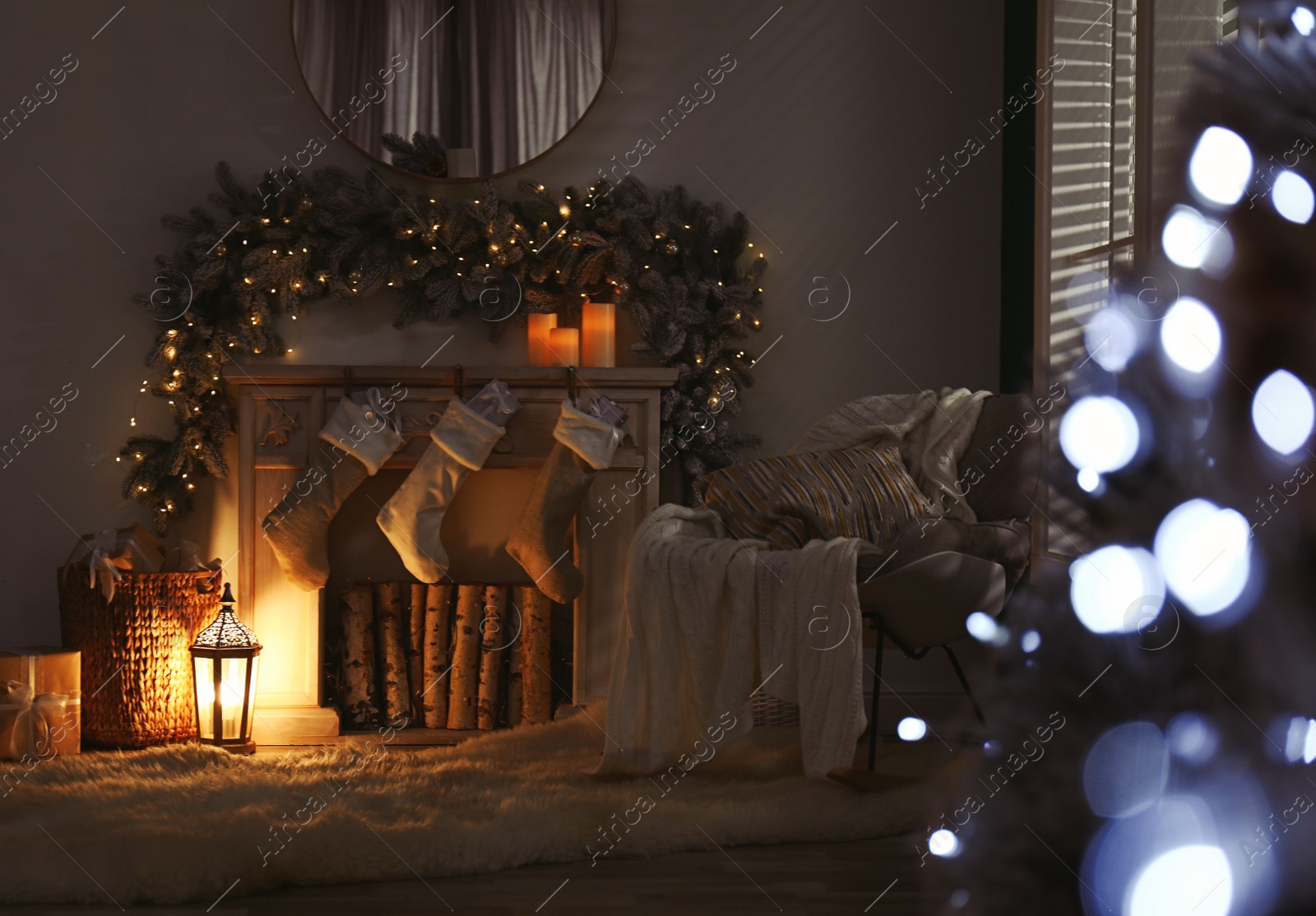 Photo of Fireplace with Christmas stockings in festive room interior