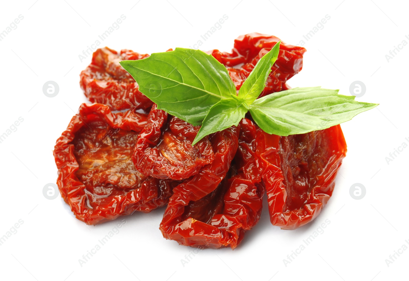 Photo of Tasty sun dried tomatoes with green leaves on white background