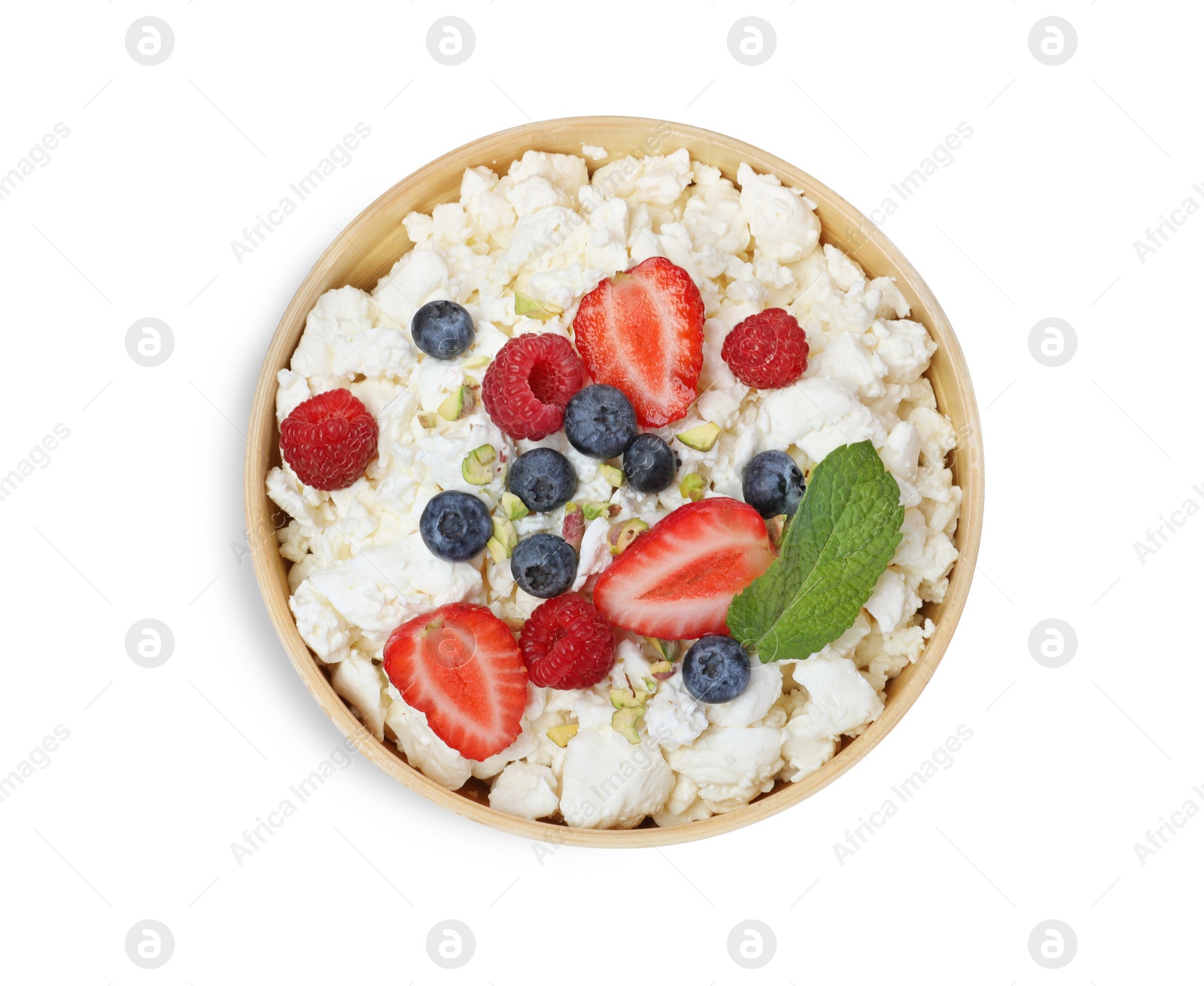 Photo of Fresh cottage cheese with berries and mint in bowl isolated on white, top view