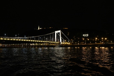 BUDAPEST, HUNGARY - APRIL 27, 2019: Beautiful night cityscape with illuminated Elisabeth Bridge across Danube river