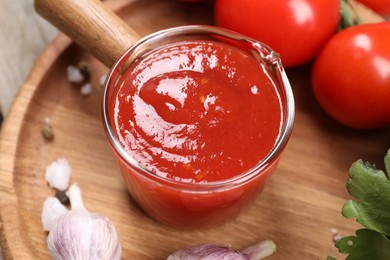 Photo of Delicious ketchup, salt and products on table, closeup. Tomato sauce