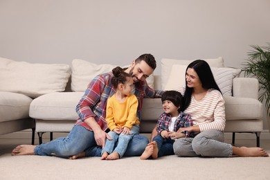 Photo of Happy family spending time together in living room