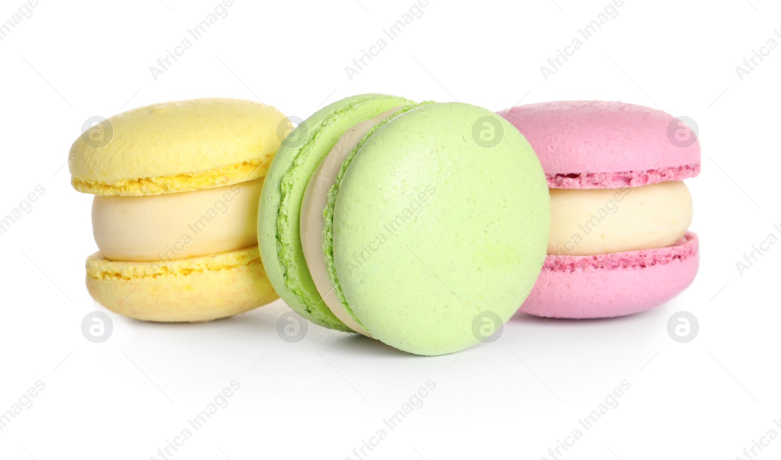 Photo of Many delicious colorful macarons on white background