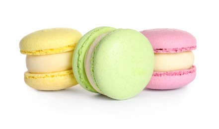 Many delicious colorful macarons on white background