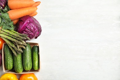 Photo of Flat lay composition with fresh vegetables and space for text on light background