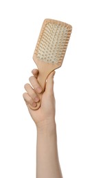 Woman holding bamboo hairbrush on white background, closeup. Conscious consumption