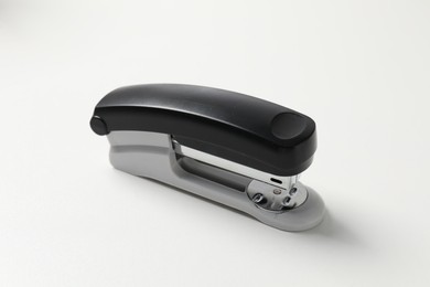 Photo of One stapler on white table. Office stationery