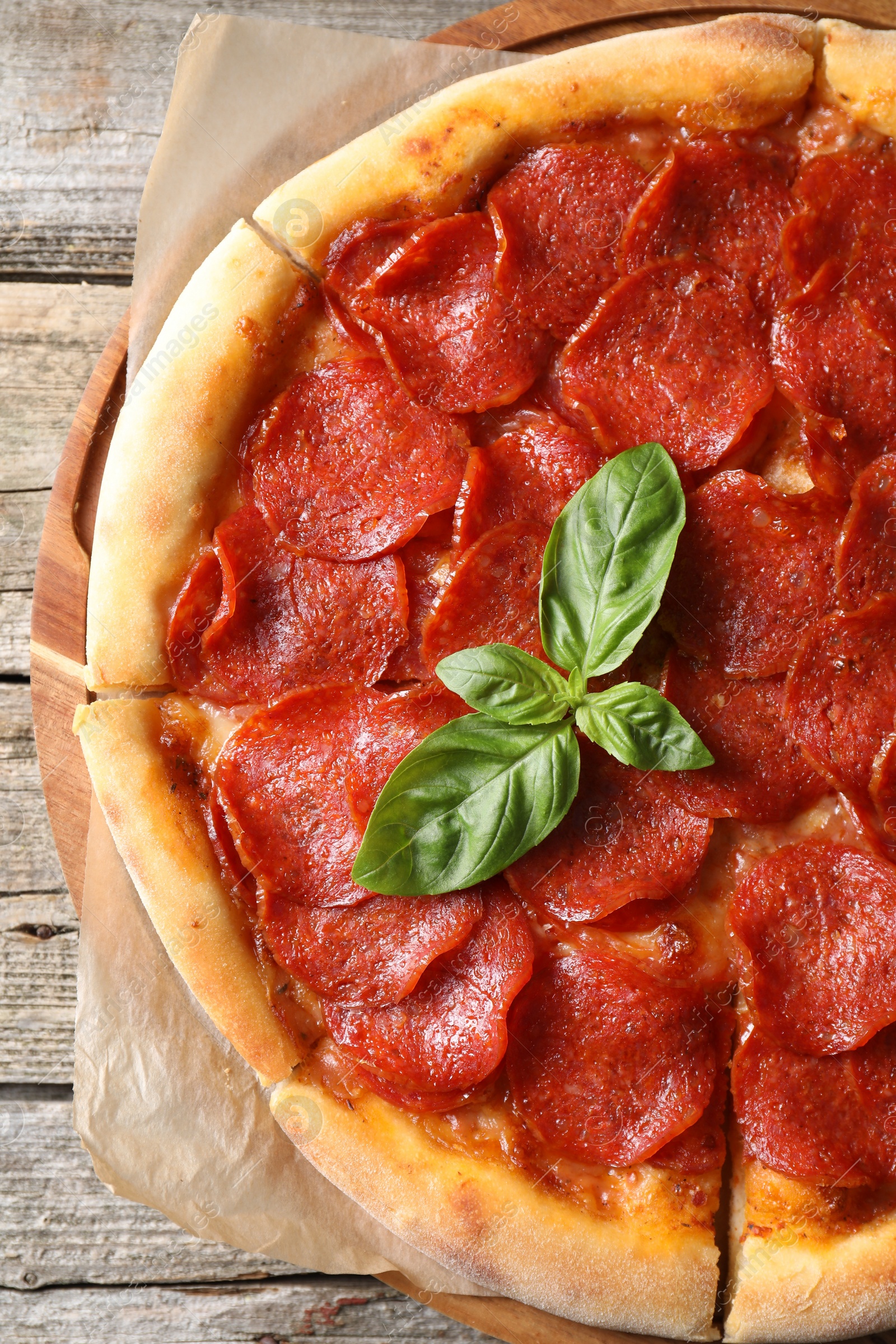 Photo of Tasty pepperoni pizza on wooden table, top view