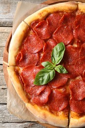 Tasty pepperoni pizza on wooden table, top view