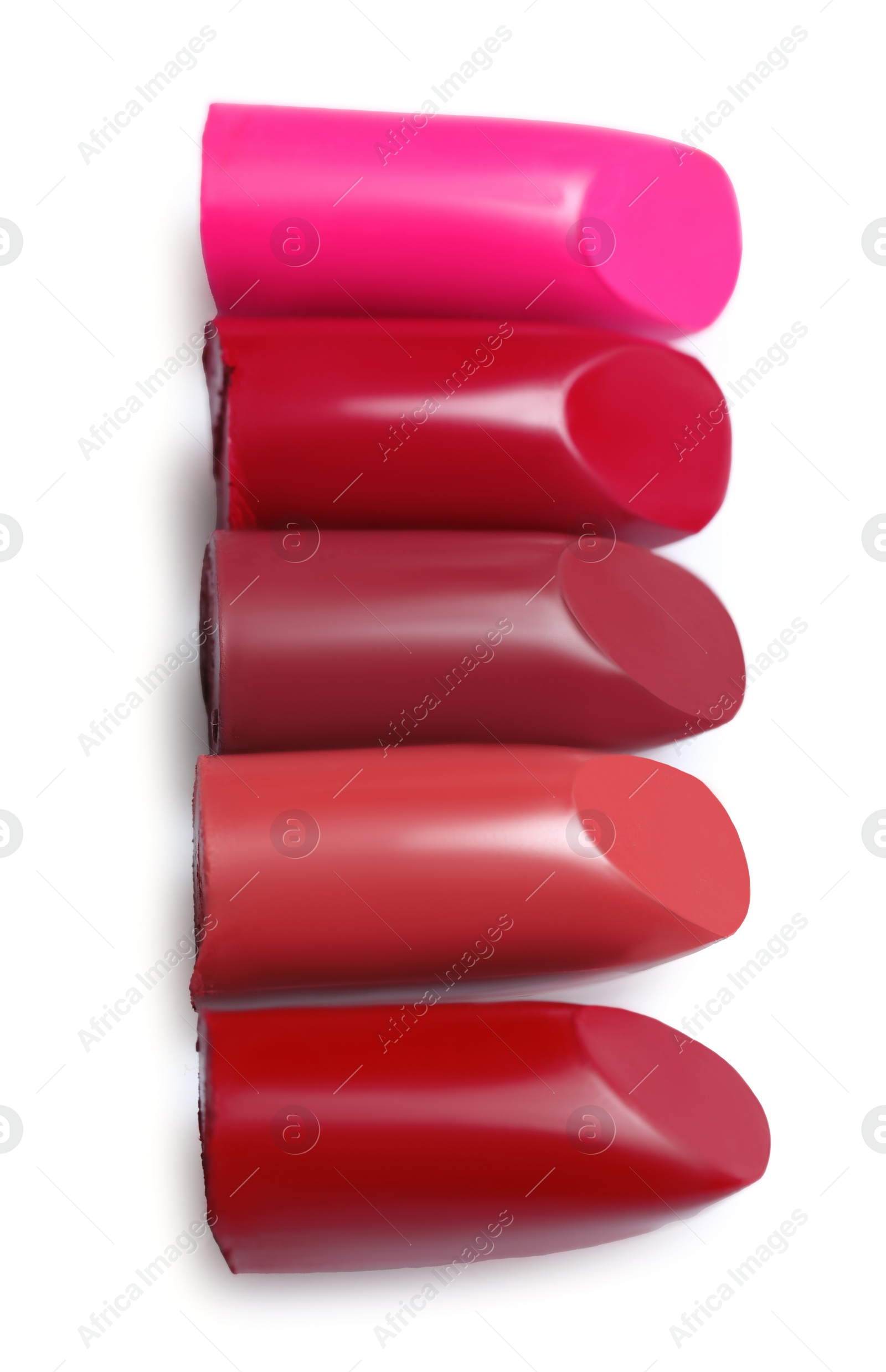 Photo of Many different bright lipsticks on white background, top view