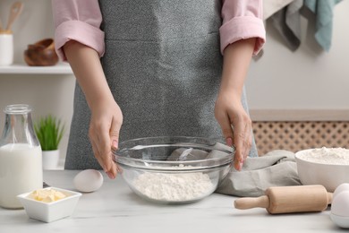 Making tasty baklava. Woman with ingredients for dough at white marble table, closeup