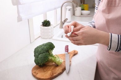 Photo of Woman cut finger while cooking in kitchen, closeup