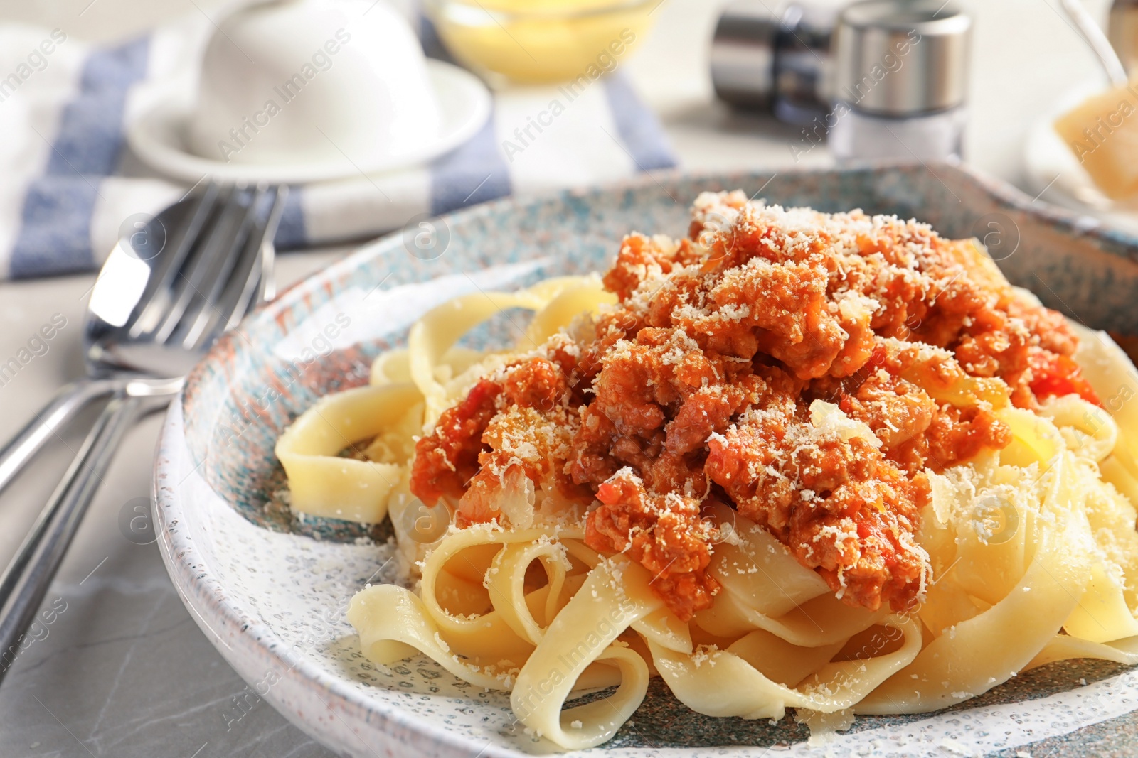 Photo of Plate with delicious pasta bolognese on table, closeup