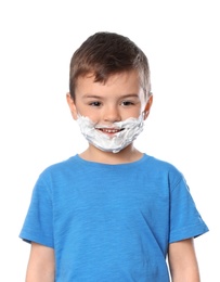 Photo of Cute little boy with shaving foam on his face against white background