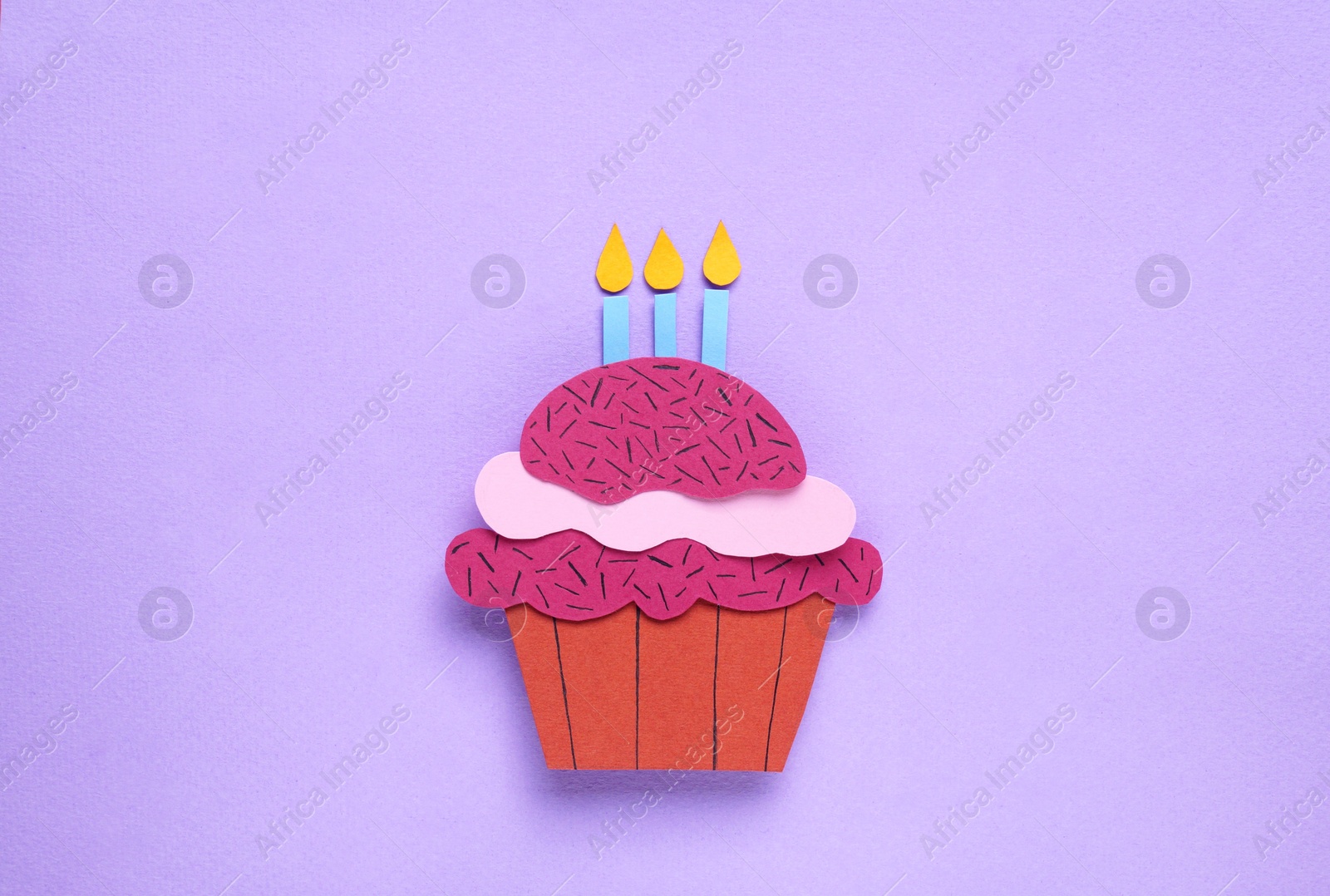 Photo of Birthday party. Paper cupcake on lilac background, top view