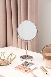 Dressing table with mirror, cosmetic products and jewelry in makeup room