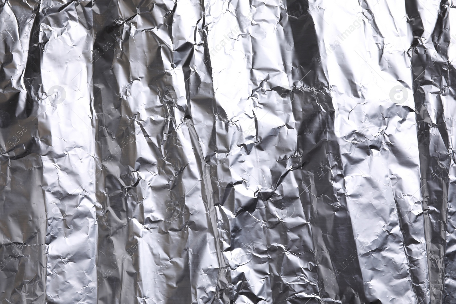 Photo of Crumpled silver foil as background, closeup view