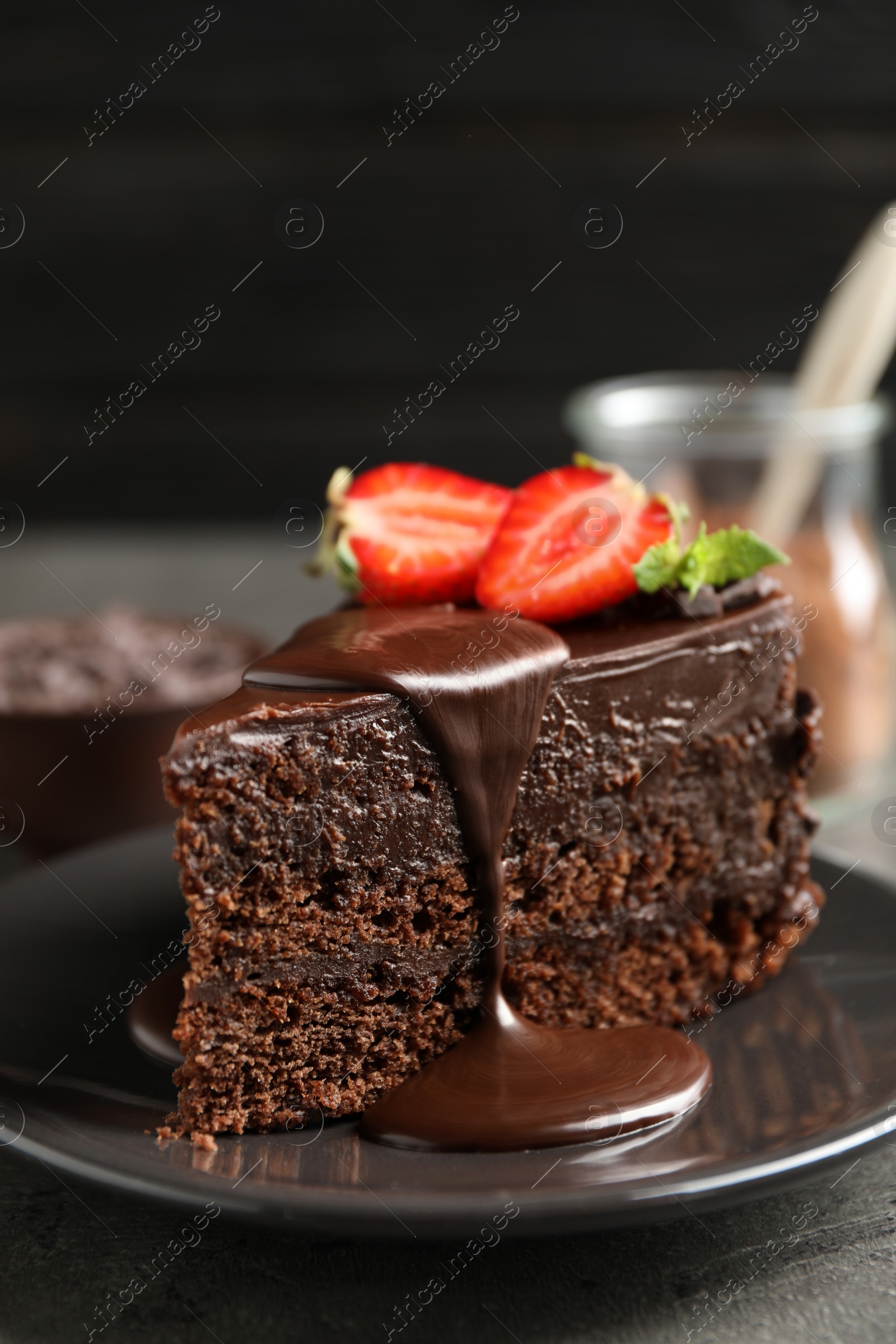 Photo of Delicious fresh chocolate cake with strawberry on grey table