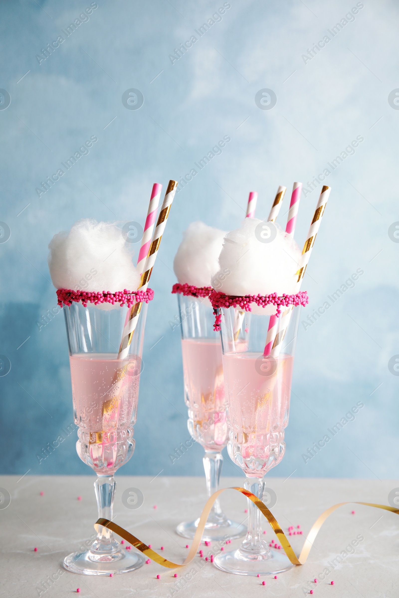 Photo of Cocktail with cotton candy in glasses on table