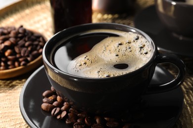 Photo of Cup of coffee and beans on serving tray, closeup