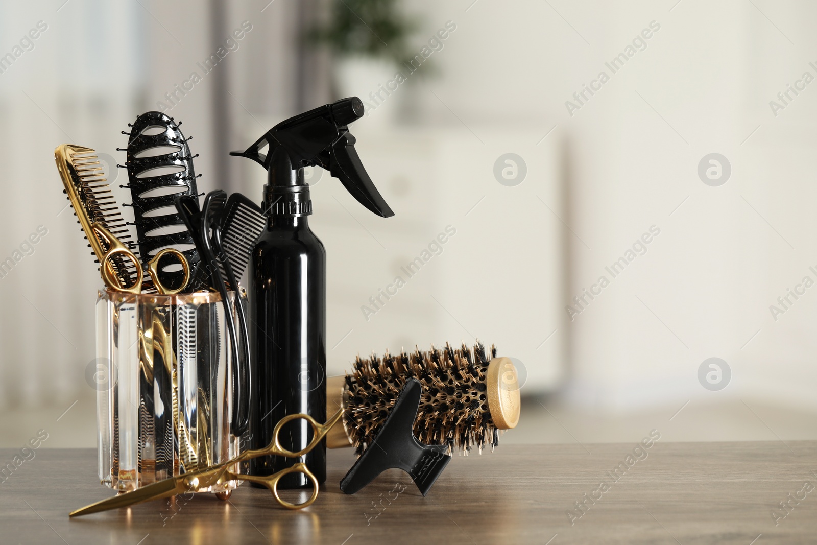 Photo of Set of hairdresser tools on table in salon, space for text