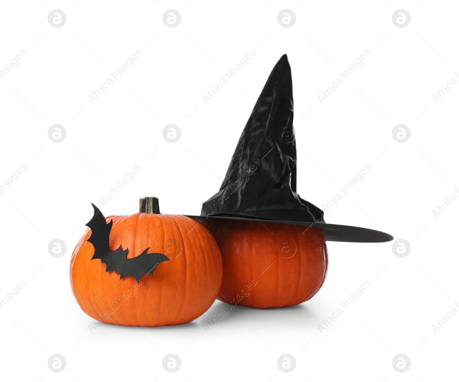 Photo of Orange pumpkins with witch hat and black paper bat isolated on white. Halloween decor
