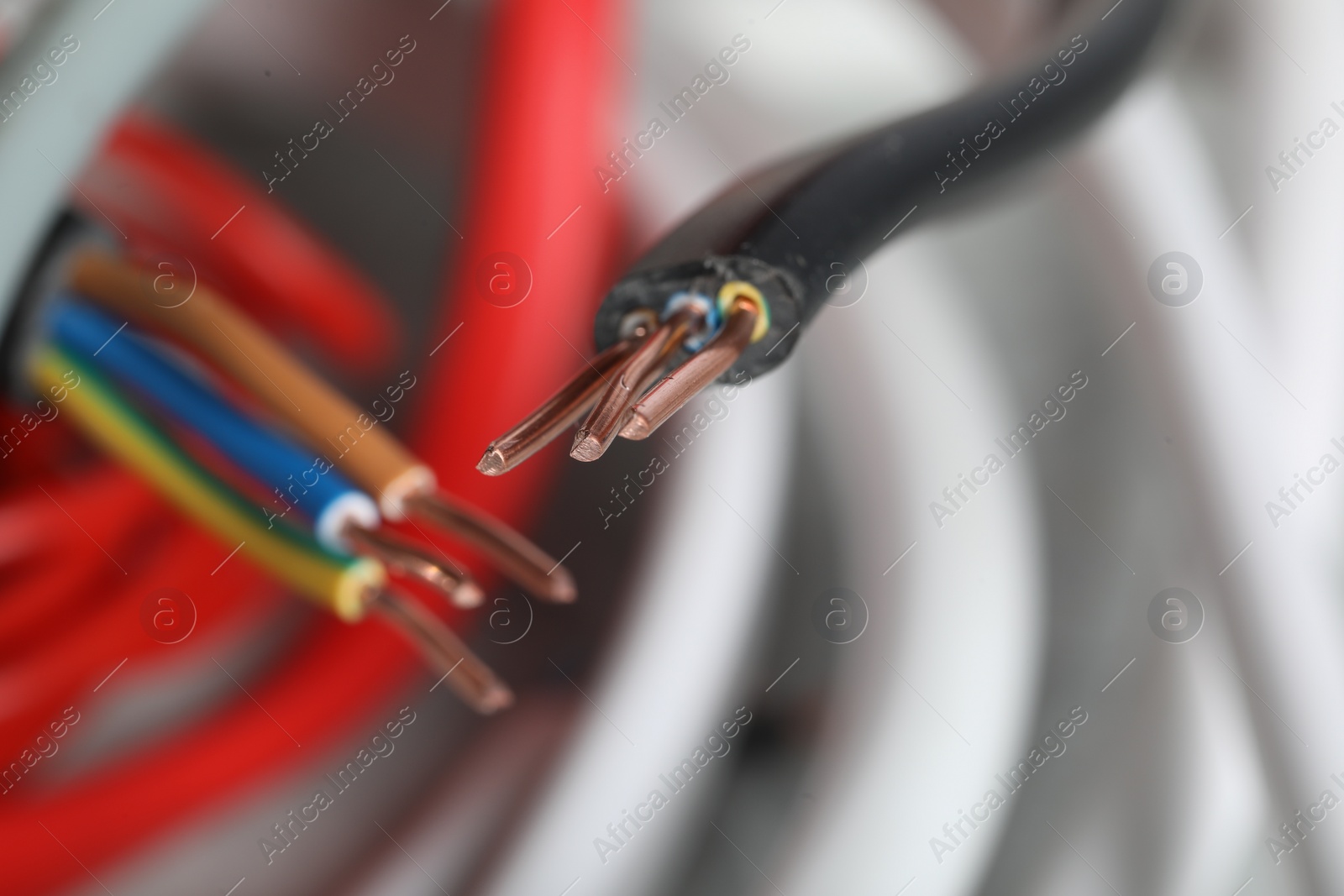 Photo of Colorful electrical wires on blurred background, closeup