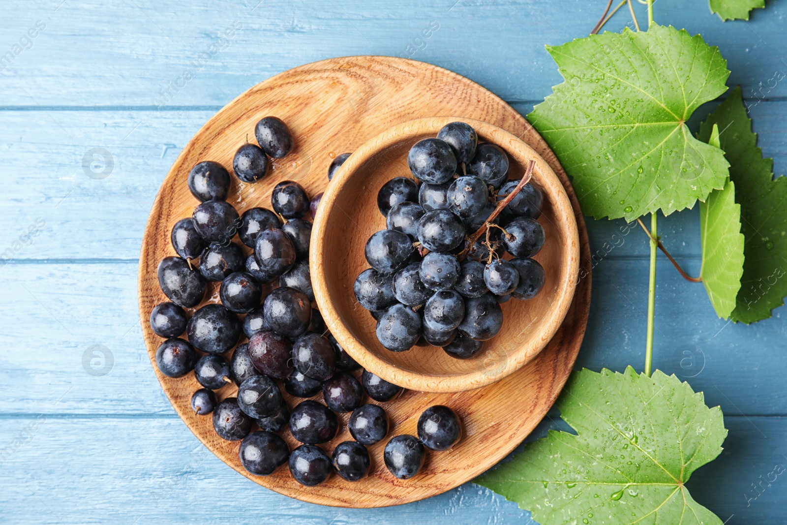 Photo of Flat lay composition with fresh ripe juicy grapes on wooden background