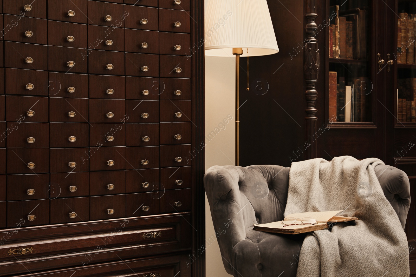 Photo of Library interior with wooden furniture and comfortable place for reading