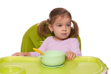 Photo of Cute little child with bowl of tasty yogurt in high chair on white background