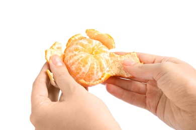 Photo of Woman peeling ripe tangerine on white background, closeup