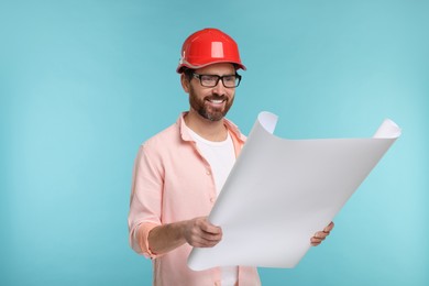 Photo of Architect in hard hat with draft on light blue background