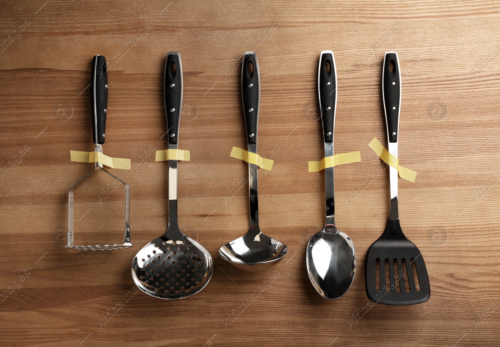 Photo of Set of clean kitchen utensils on wooden background, flat lay