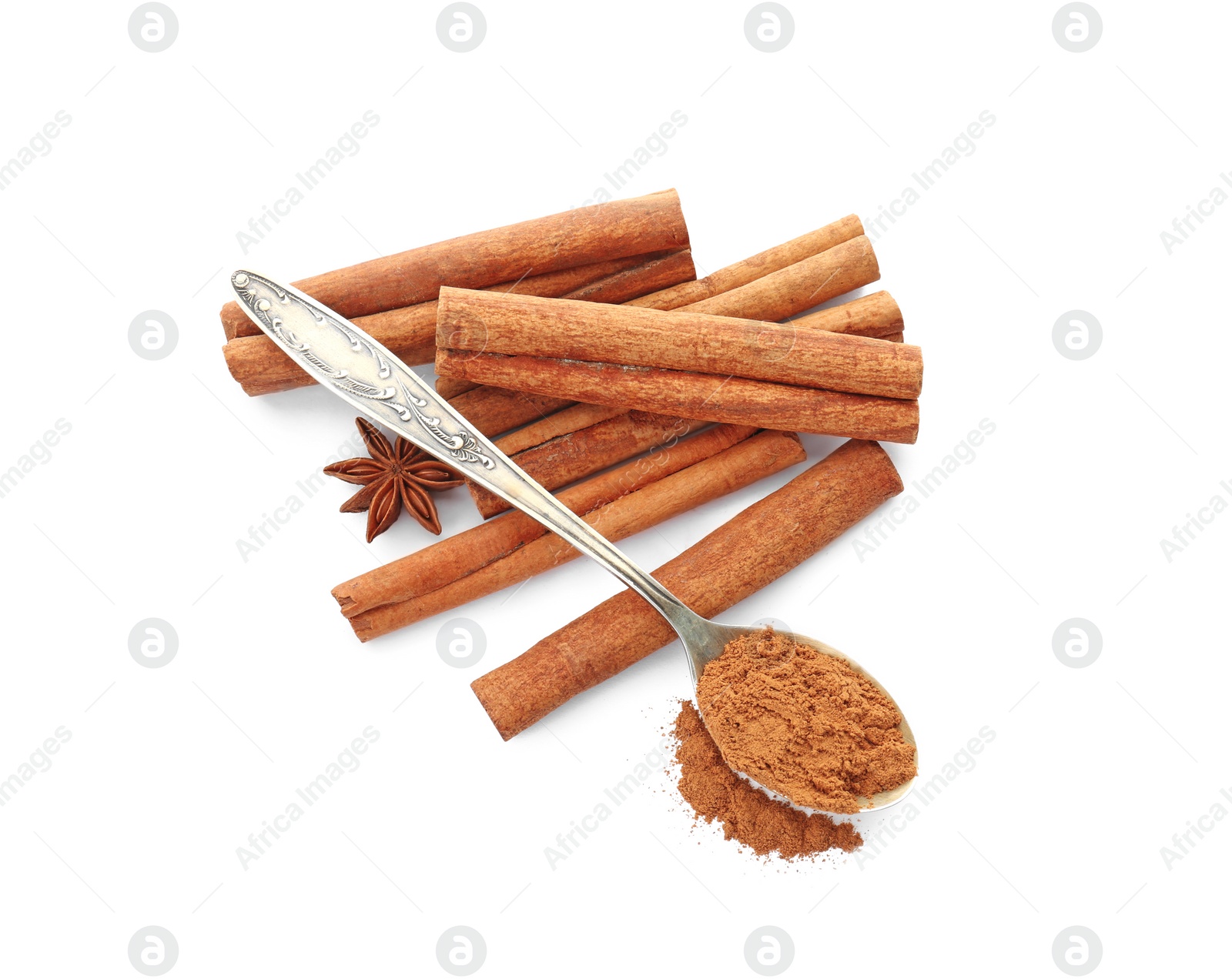 Photo of Aromatic cinnamon sticks and spoon with powder on white background