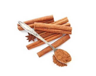 Aromatic cinnamon sticks and spoon with powder on white background