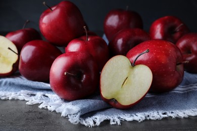 Photo of Fresh ripe red apples on grey table, closeup
