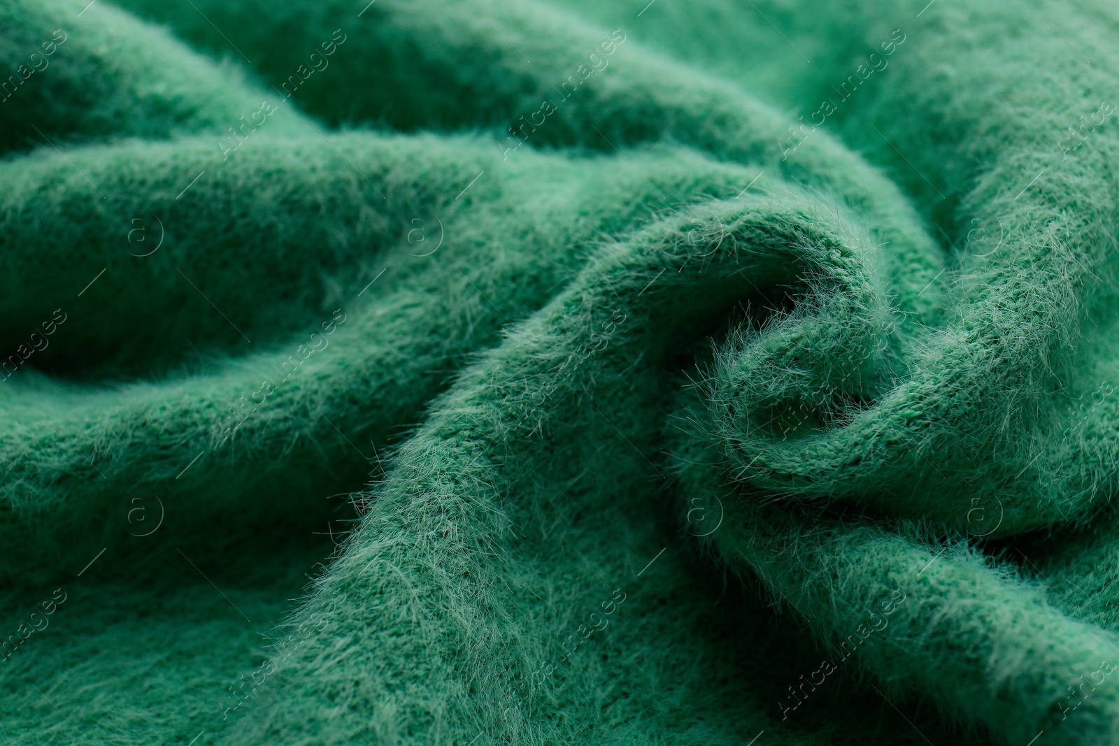 Photo of Beautiful green fabric as background, closeup view