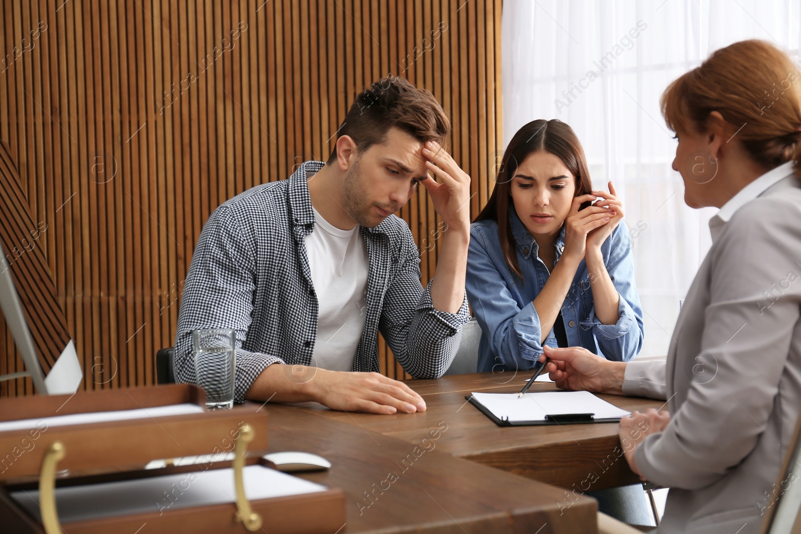 Photo of Lawyer having meeting with young couple in office