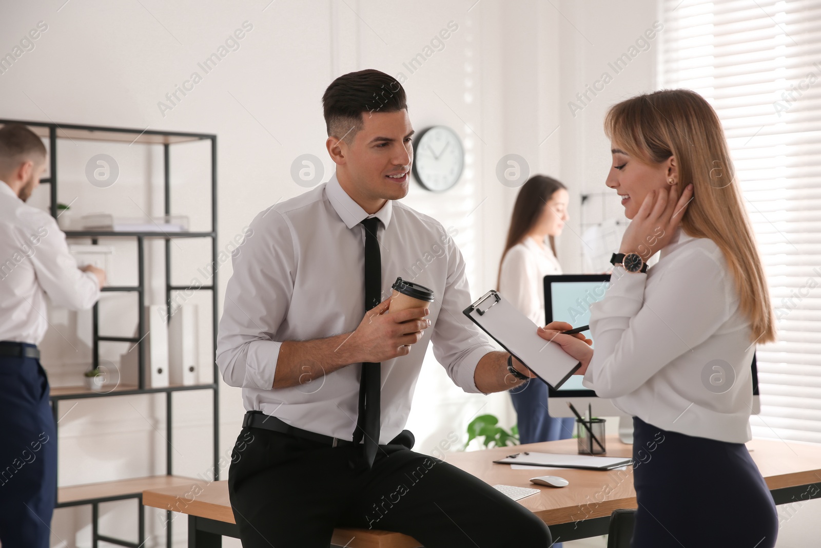 Photo of Colleagues flirting with each other during work in office