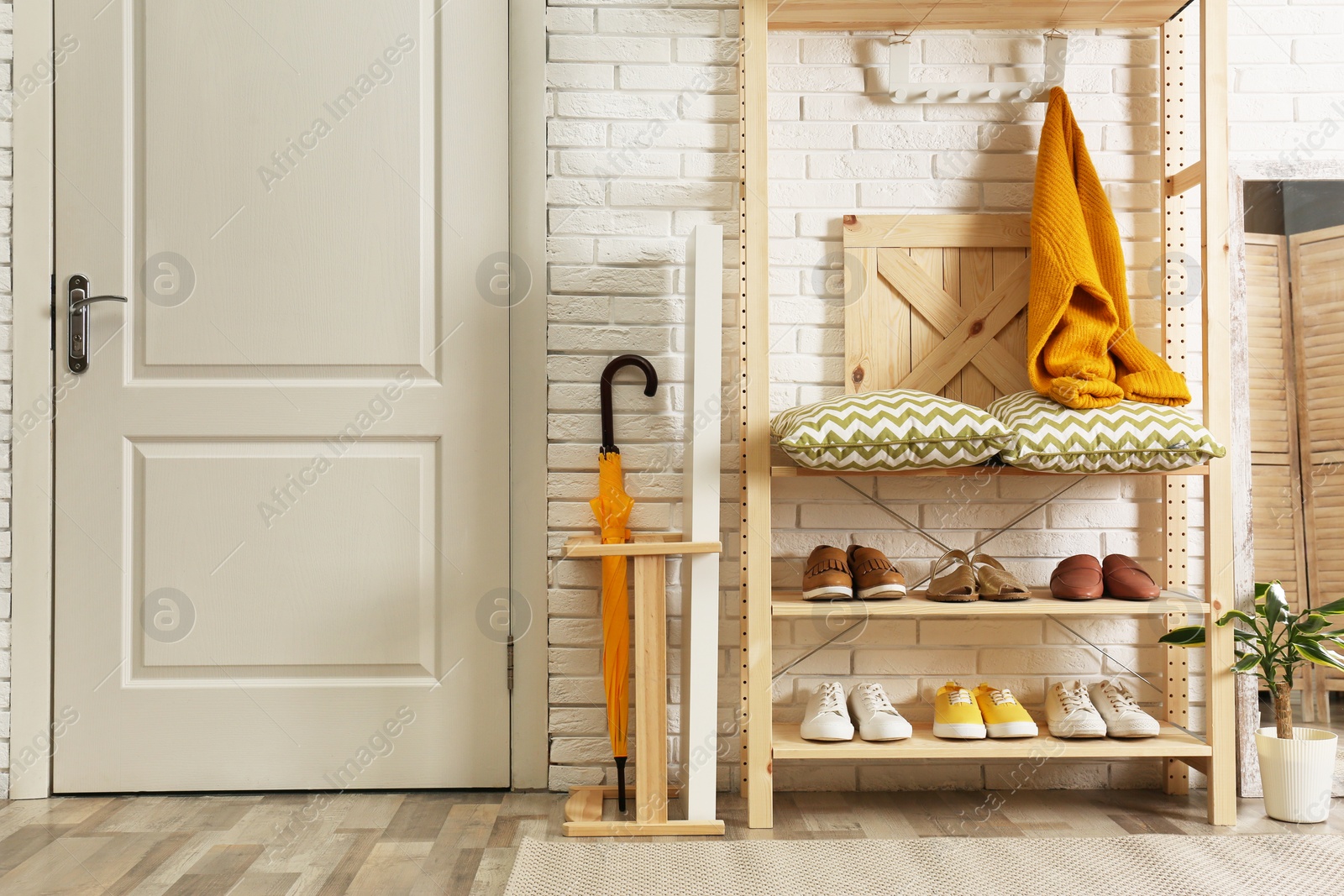 Photo of Cozy hallway interior with wooden shelving unit. Stylish design idea