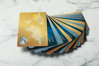 Many different credit cards on white marble background