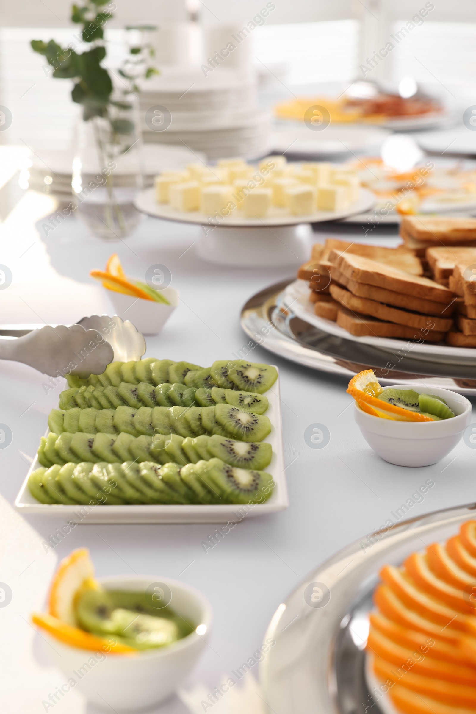 Photo of Different meals for breakfast on white table indoors. Buffet service